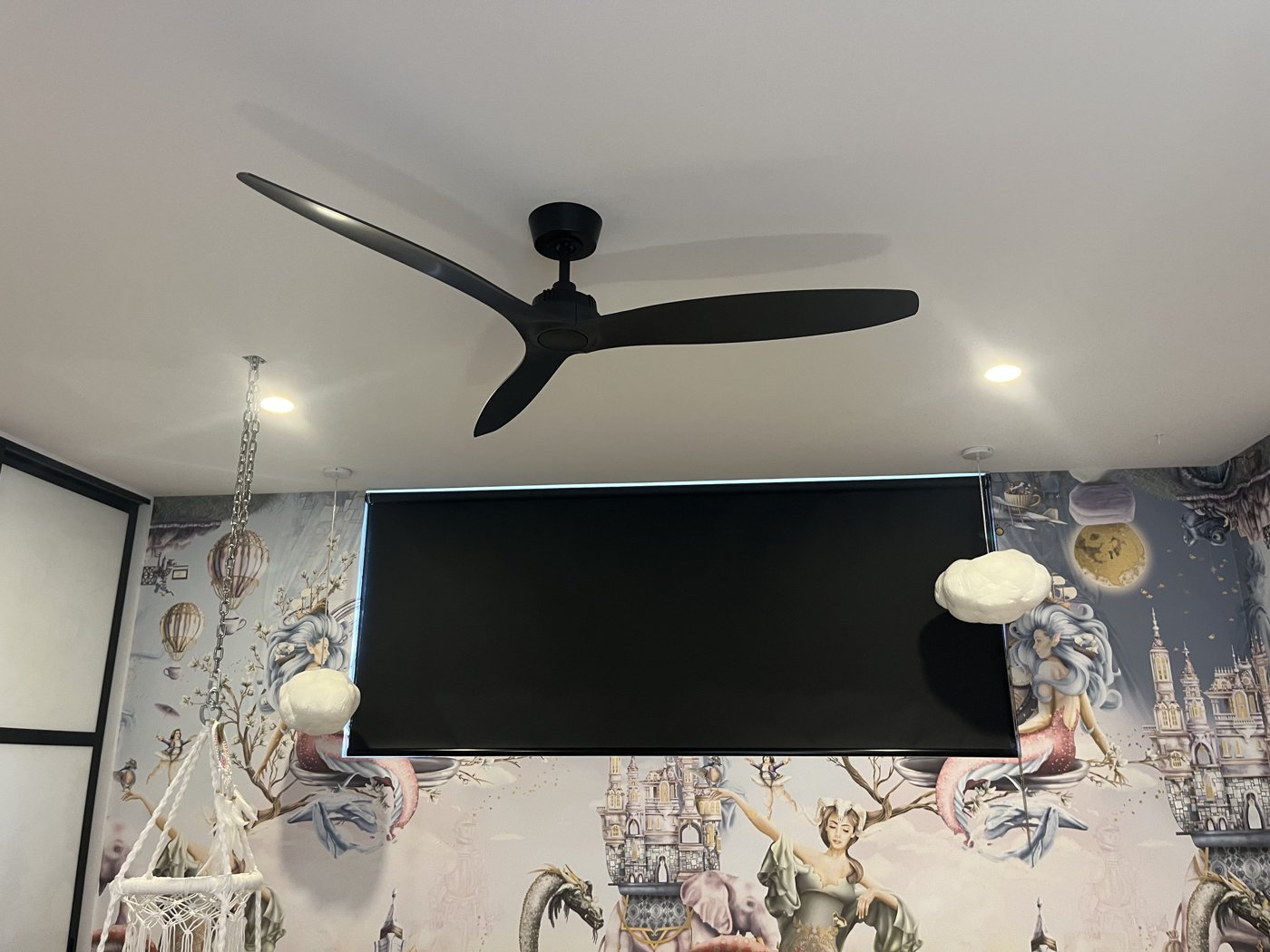 Modern matte black ceiling fan installed in a bedroom