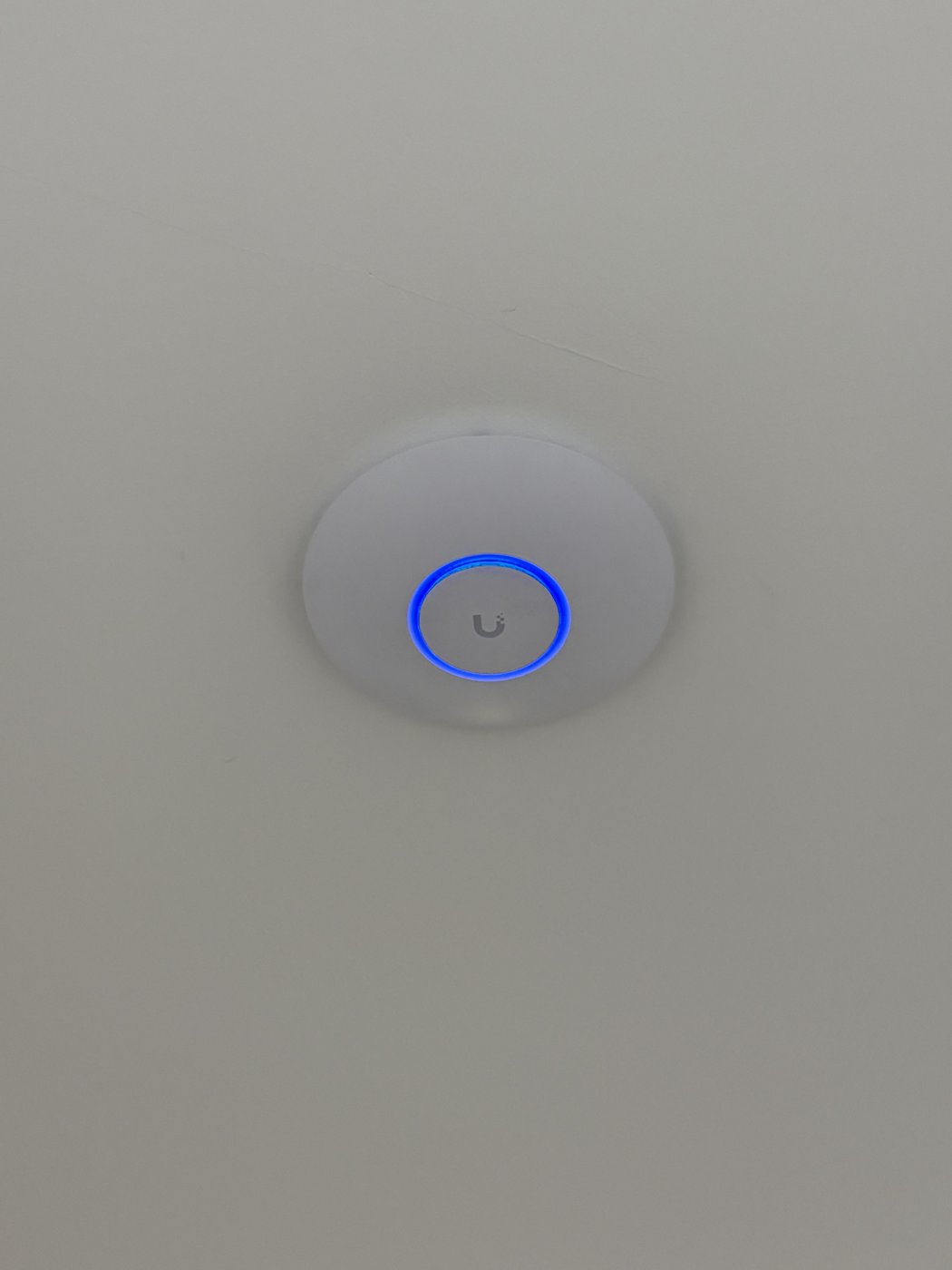Ubiquiti WiFi access point flush-mounted on a ceiling