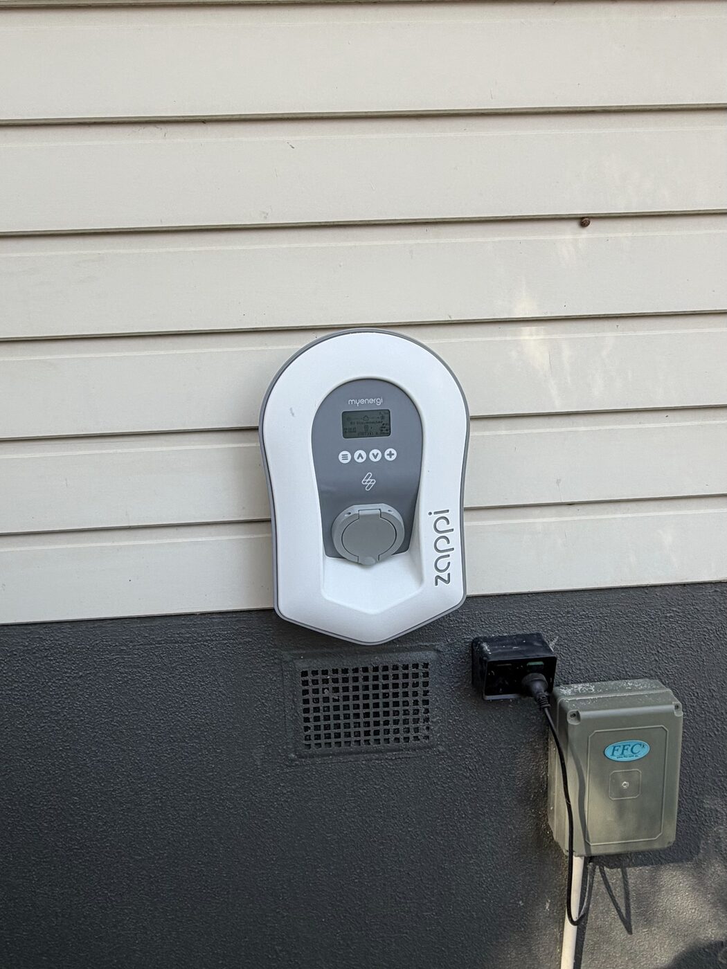 Zappi EV charger installed on an exterior wall
