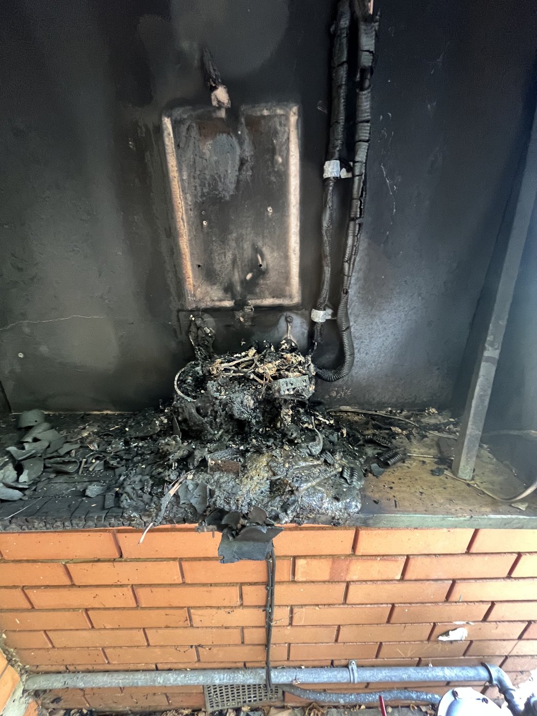 Close-up of switchboard components melted and destroyed by fire