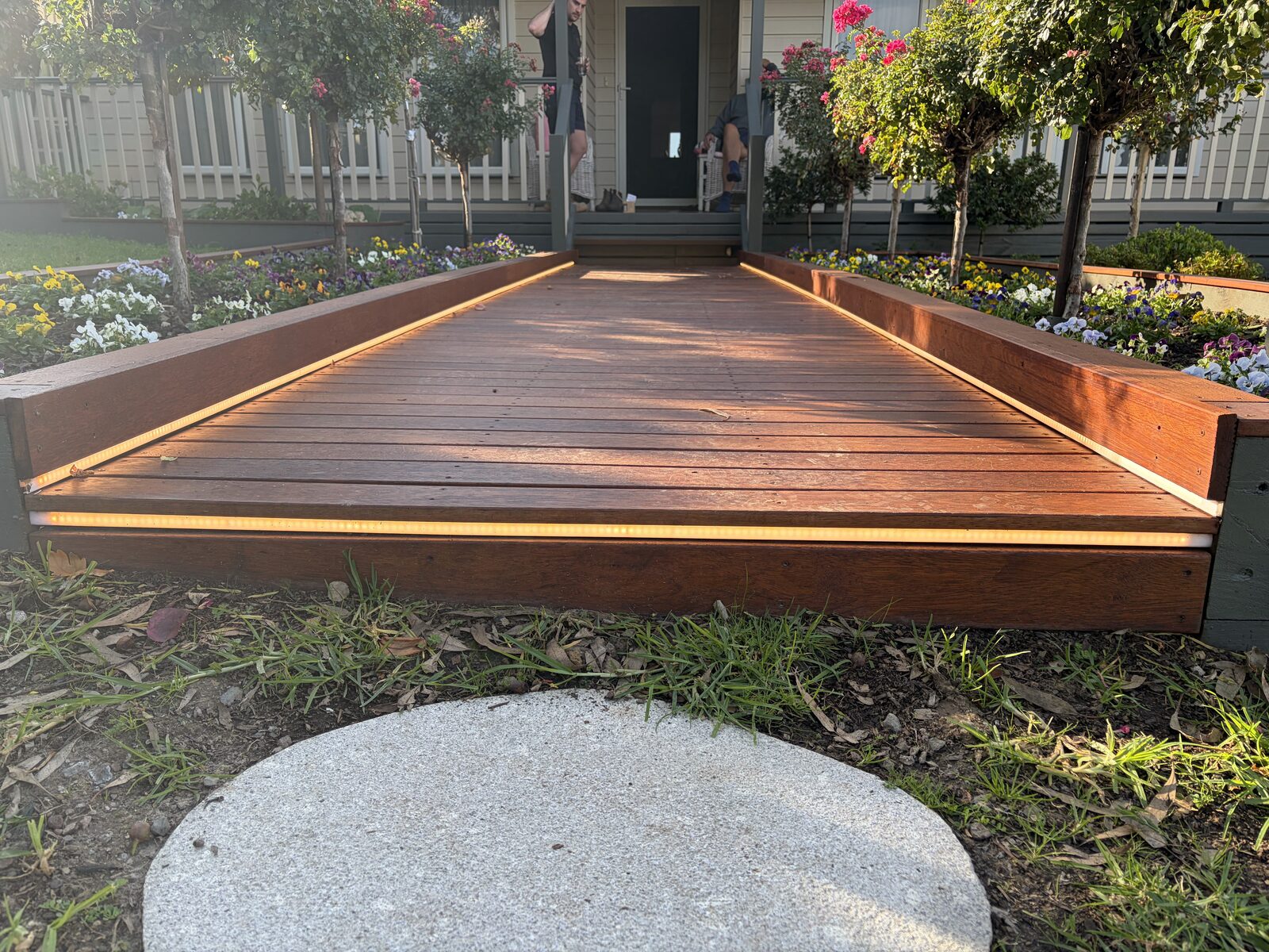 LED deck edge lighting installed along a timber deck at golden hour