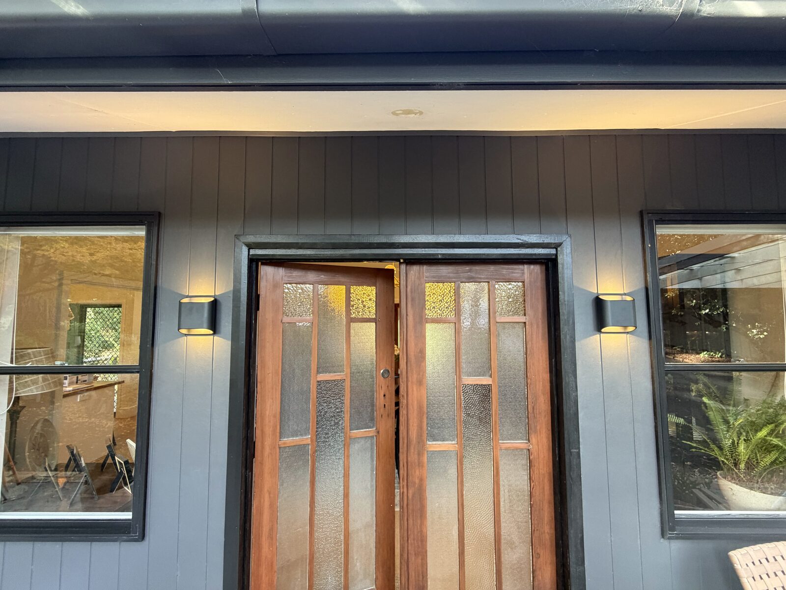 Exterior wall lighting either side of a front entry door