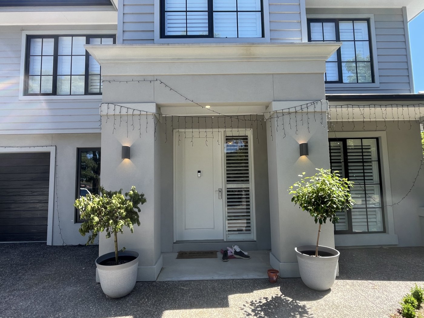 Wall lights either side of a home entry portico