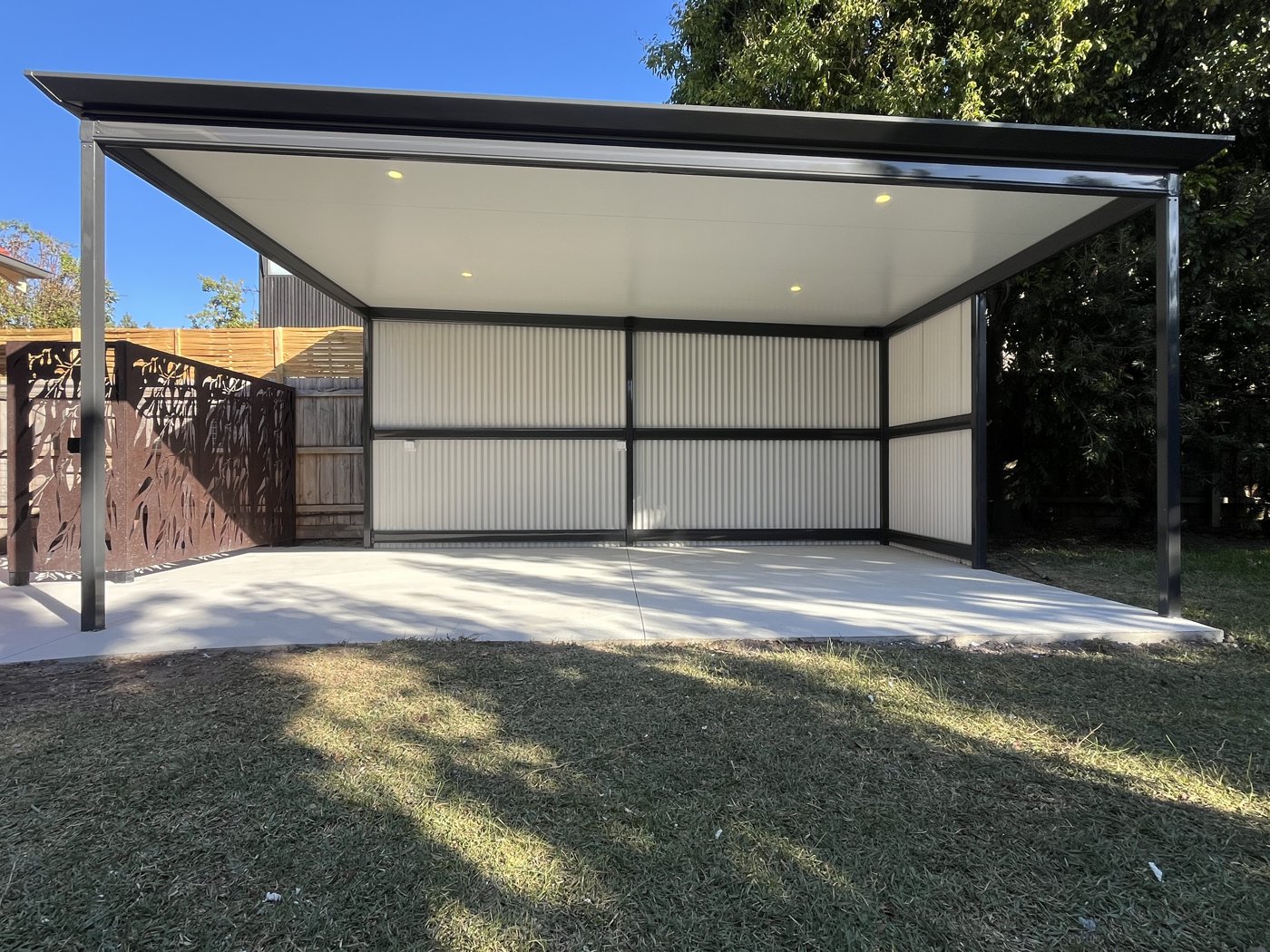 Recessed downlights installed in an outdoor alfresco structure