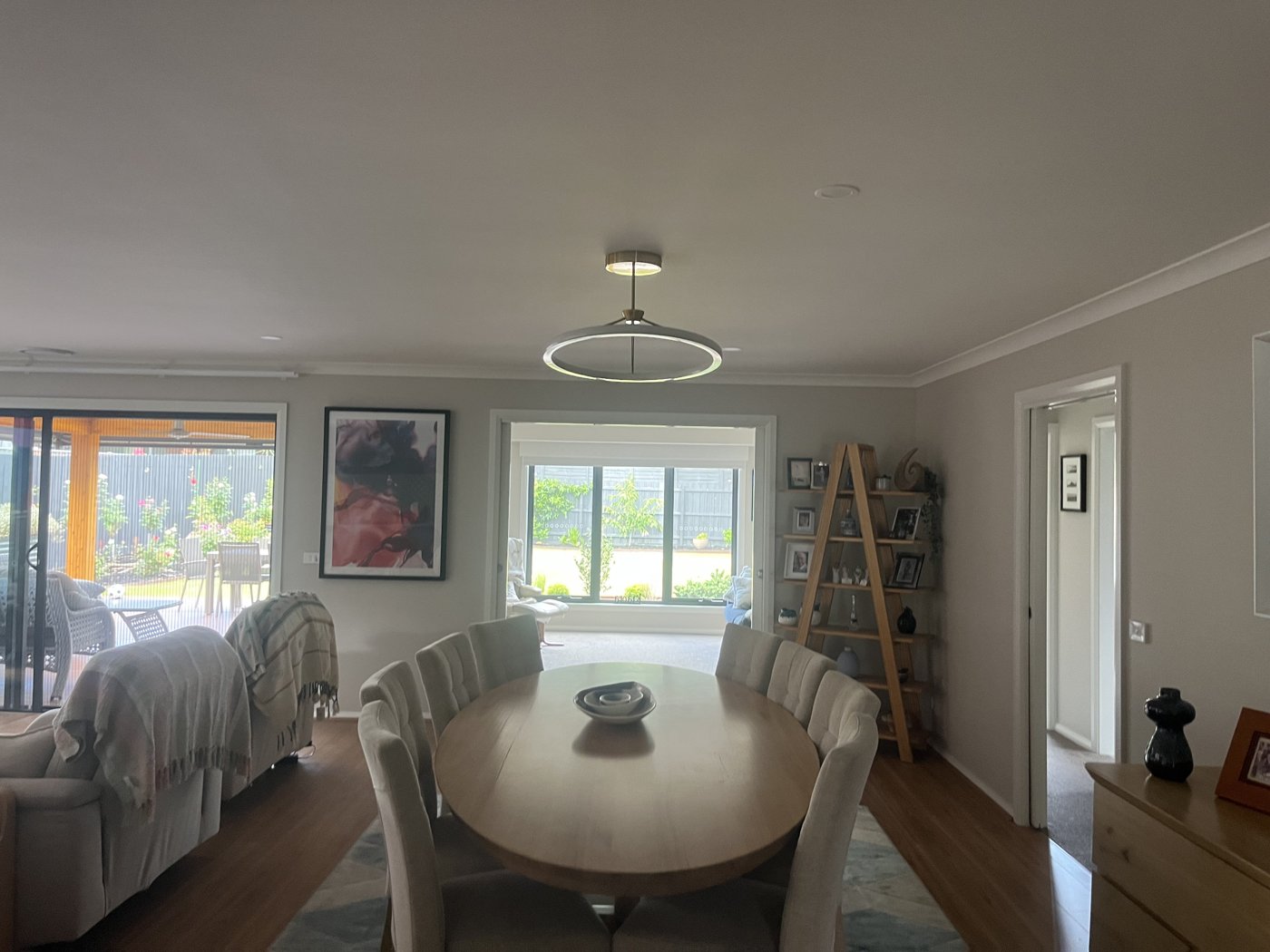Circular ring pendant light installed above a round dining table