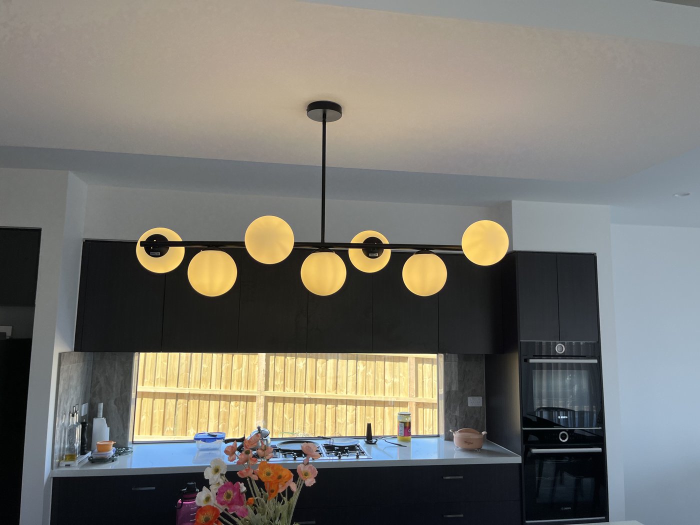 Statement orbital cluster pendant light installed above a kitchen island