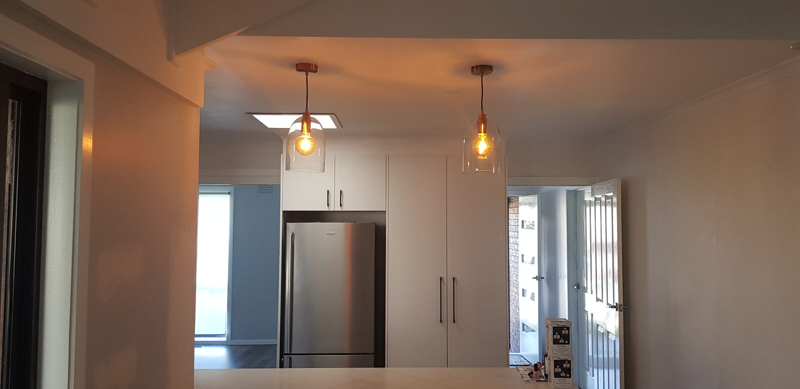 Twin pendant lights installed above a kitchen island