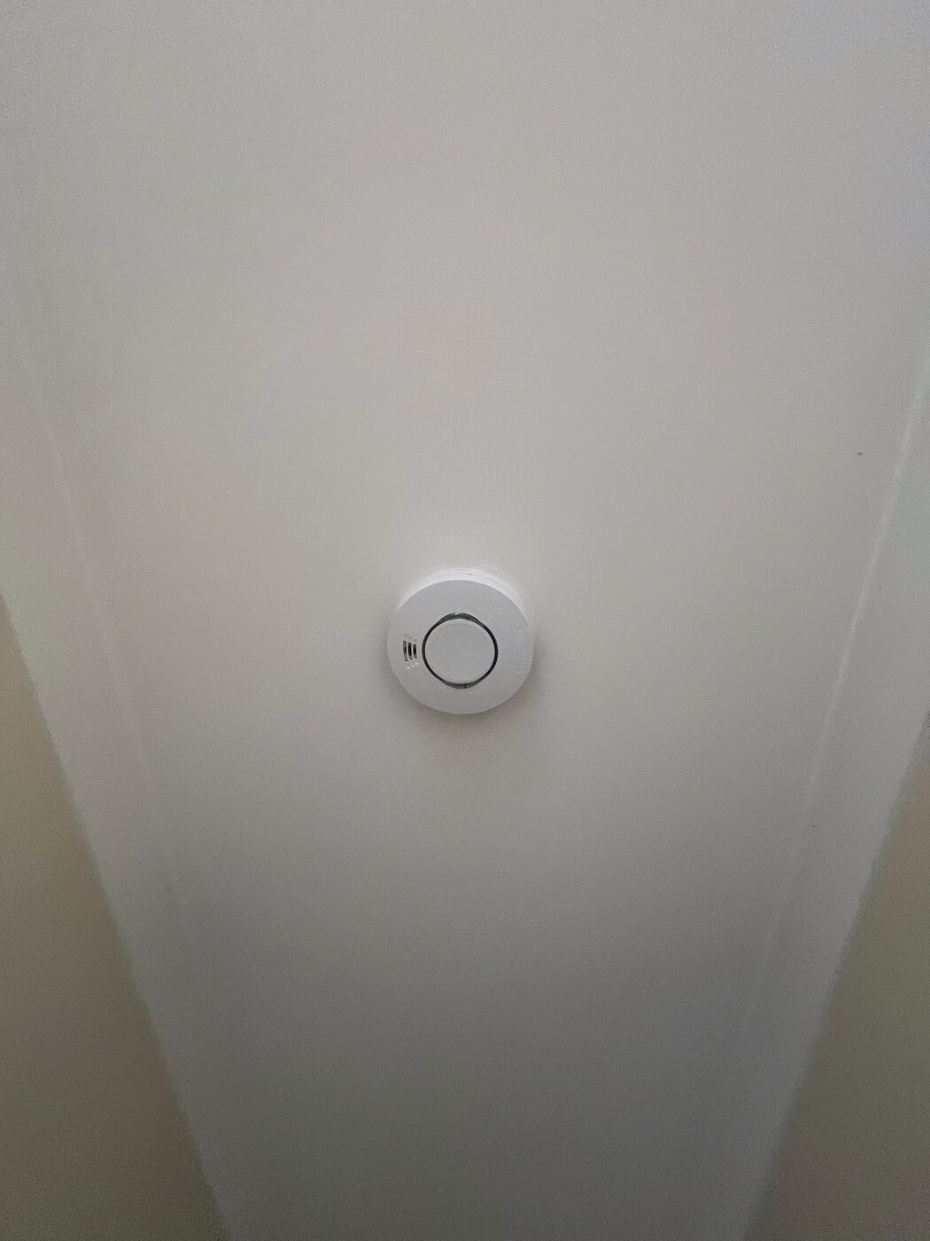Photoelectric smoke alarm installed on a bedroom ceiling