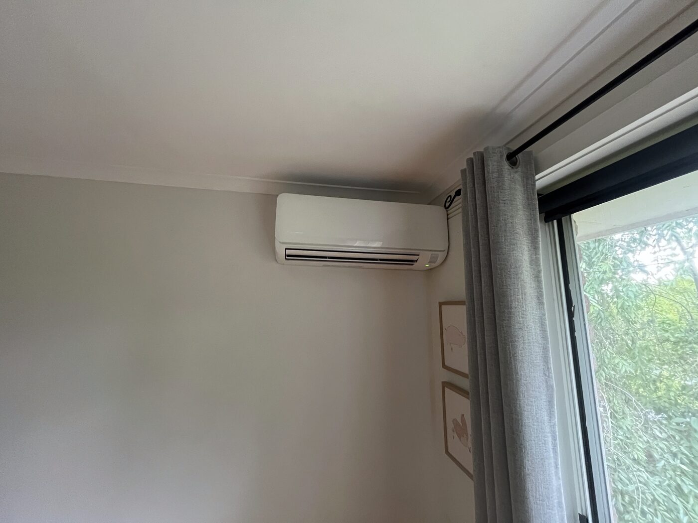 Split system indoor unit installed near a bedroom window