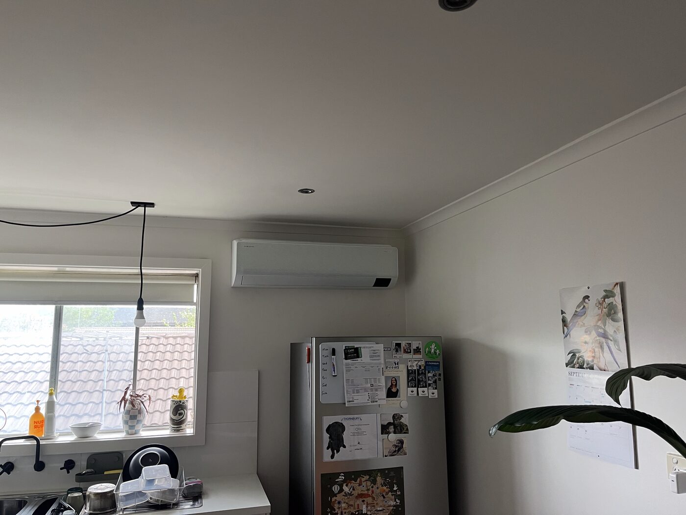 Split system indoor unit installed in a kitchen and living area