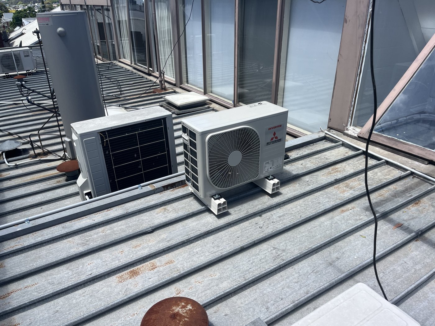Two split system outdoor units installed on an apartment balcony