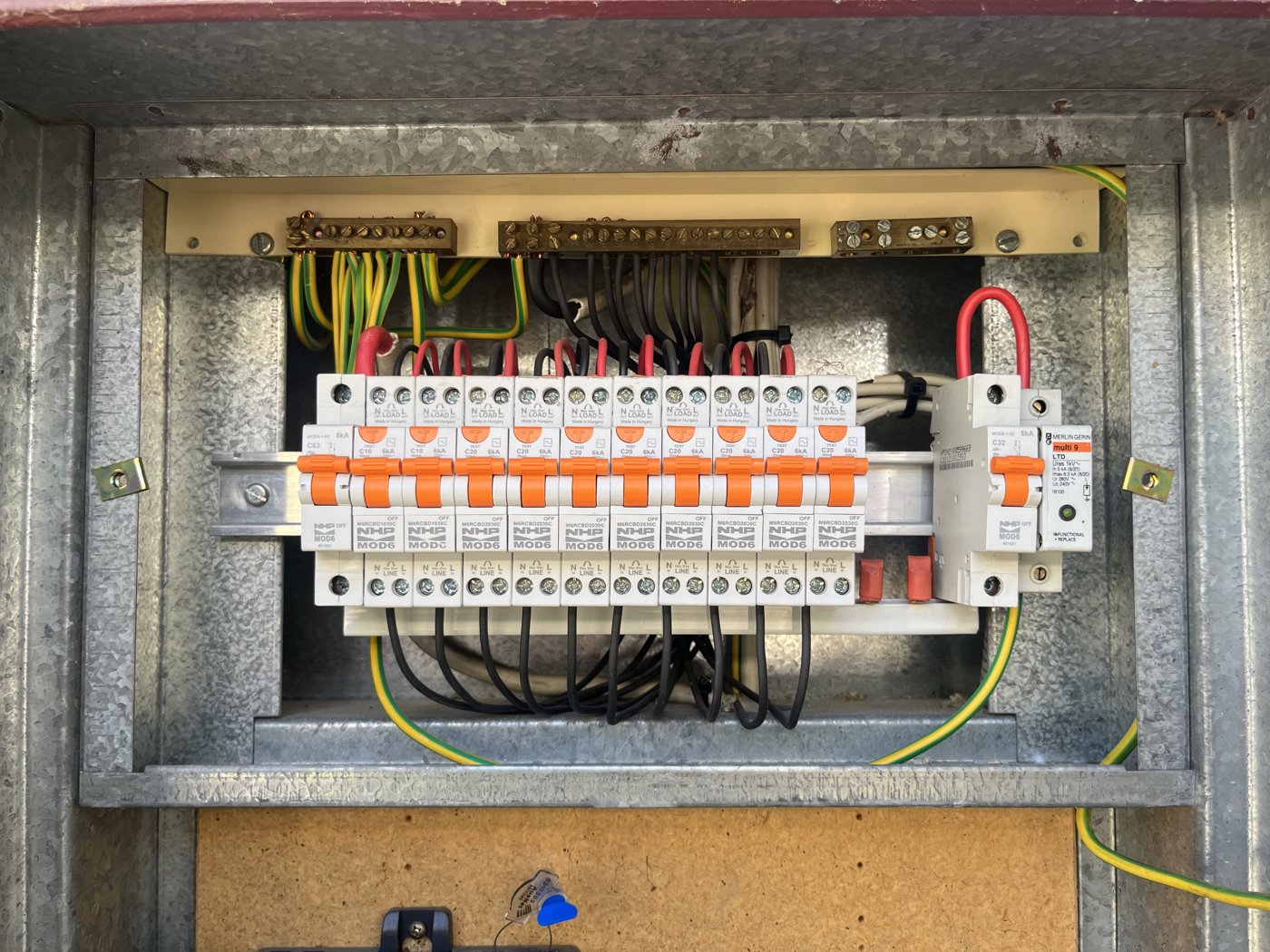 Switchboard mid-install with circuit breakers being wired